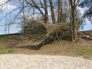 Roland Mayer. Observer, 2010 Saplings and branches, wire. Length 8 m. Mangfall river bank Rosenheim. www.mayerrolandart.de